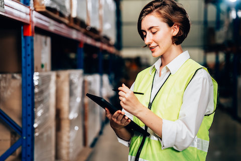 woman with tablet in warehouse
